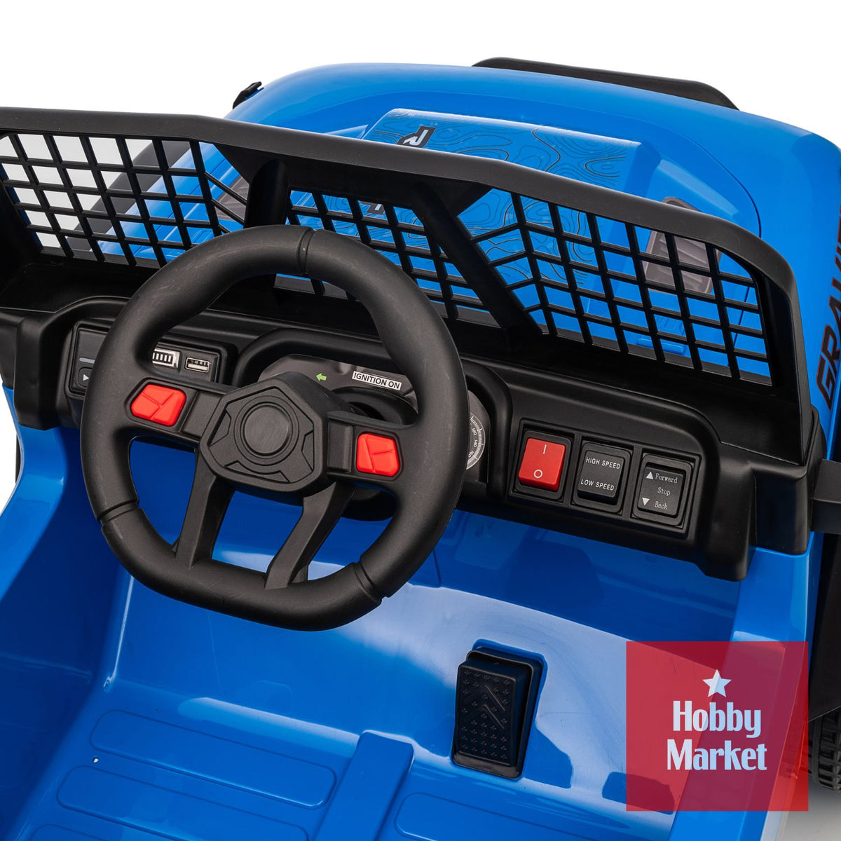 Interior de jeep eléctrico azul para niños con volante, tablero detallado, interruptores de velocidad y pedal de aceleración.