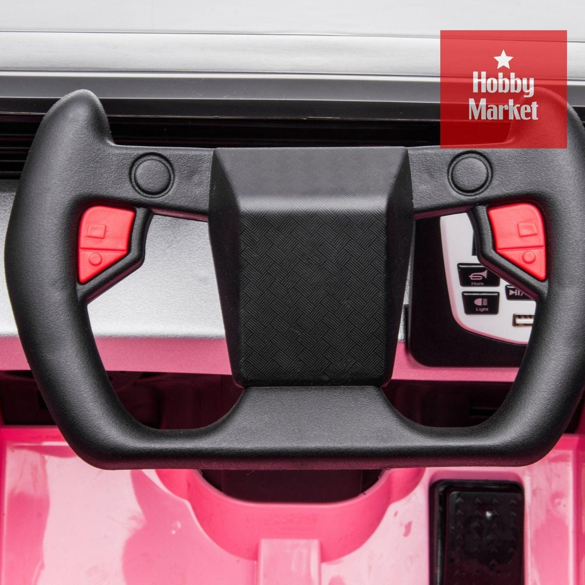 Volante deportivo negro con botones rojos y panel de control integrado en vehículo infantil Cyber rosa.