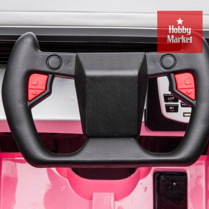 Volante deportivo negro con botones rojos y panel de control integrado en vehículo infantil Cyber rosa.