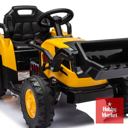 Tractor eléctrico infantil amarillo de 12V con pala frontal, asiento negro y ruedas todoterreno resistentes.